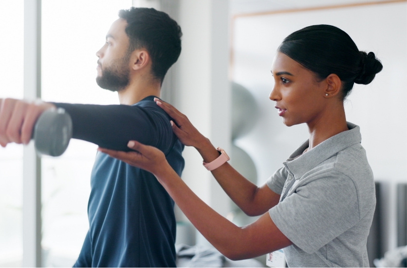 Female clinician helping male patient